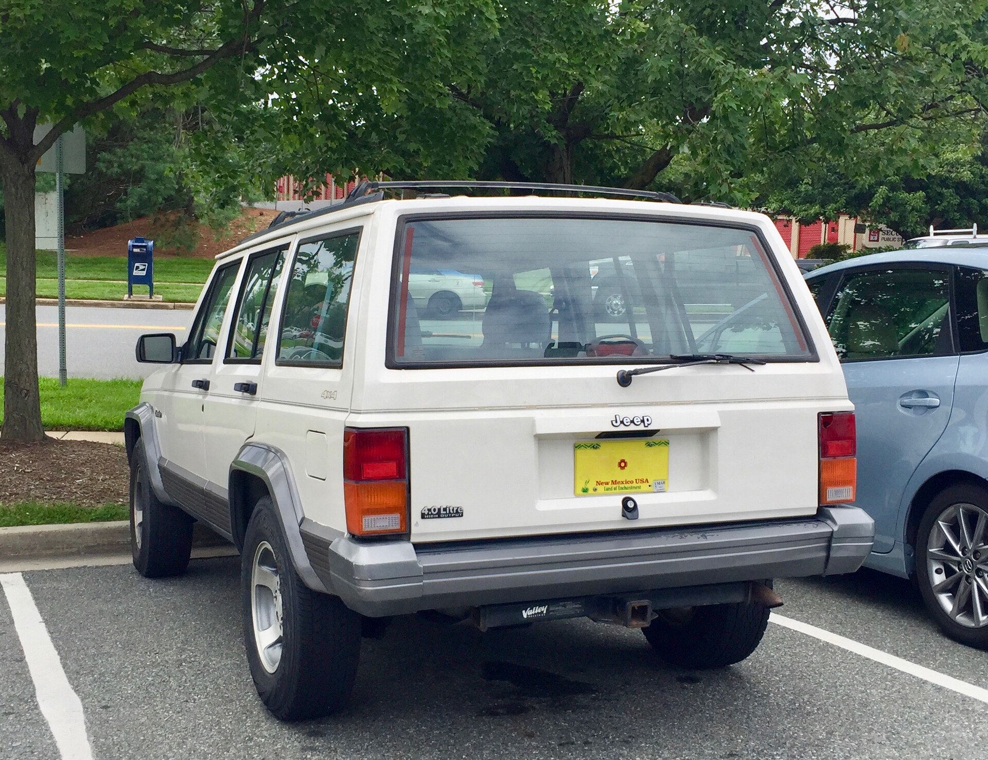 A white four-door Jeep Cherokee XJ