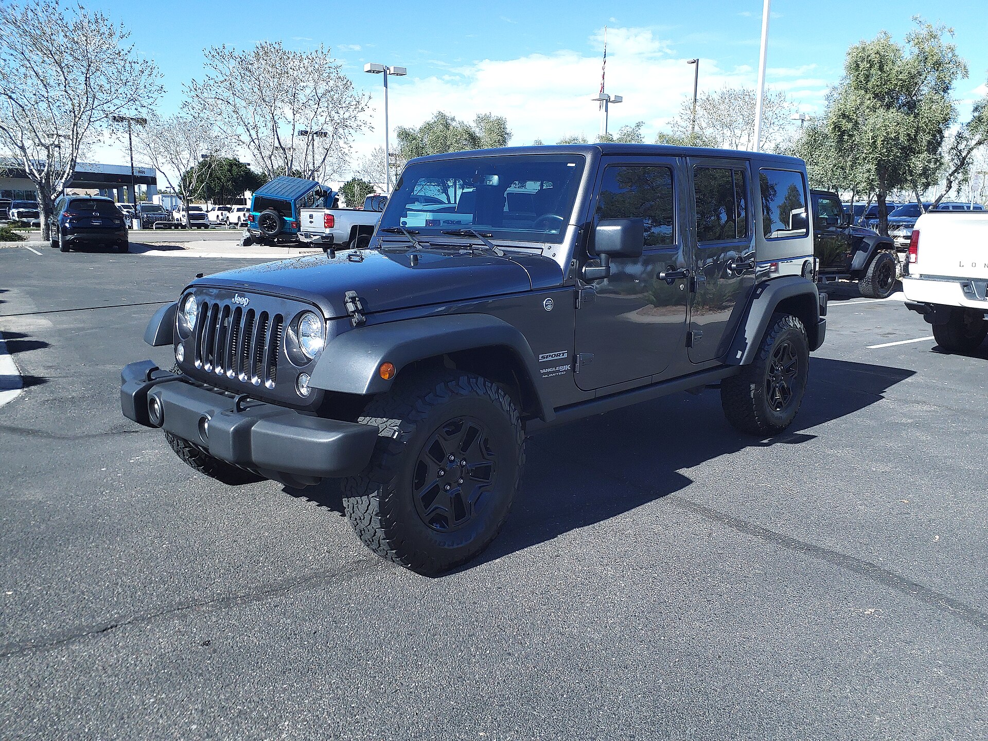 A gray Jeep Wrangler JK Unlimited four-door